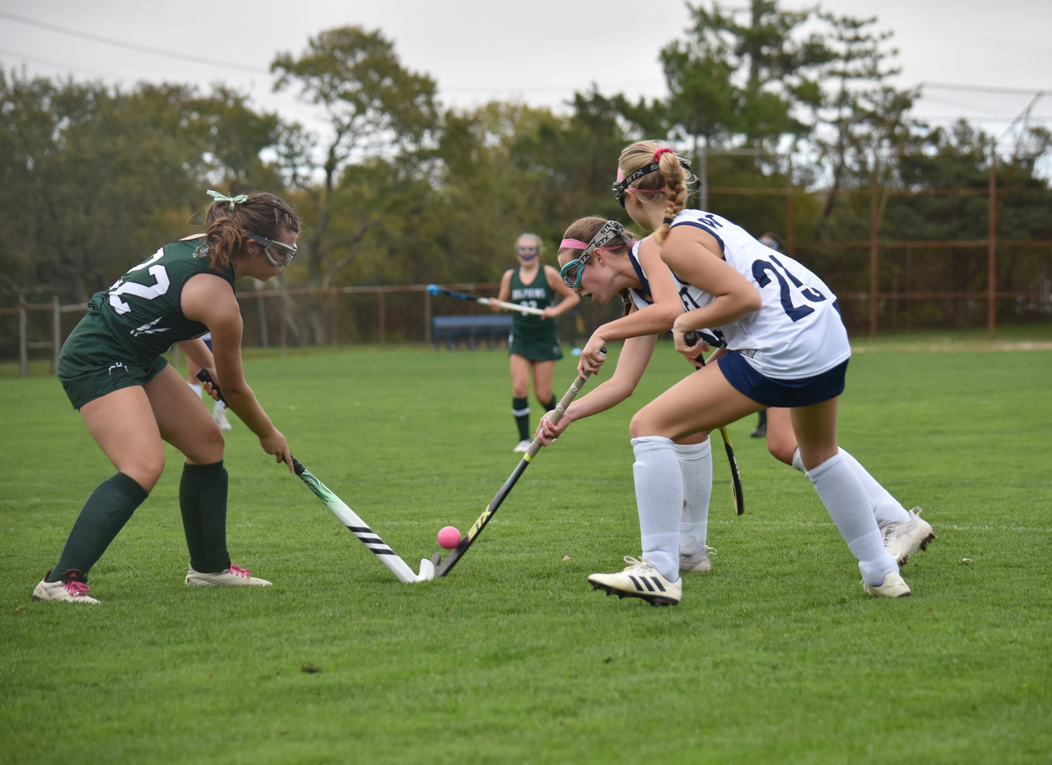 Lillian Wullschleger, right, and a Dennis-Yarmouth player battle for the ball while Clementine Kelly (25) watches.
