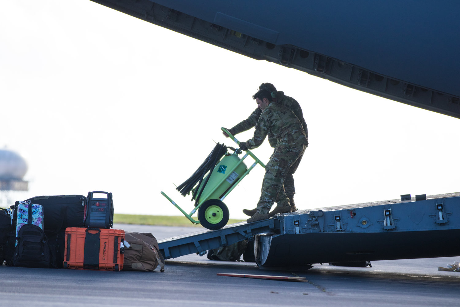 Federal personnel unload equipment from a U.S. Air National Guard C-17 Globemaster Saturday.