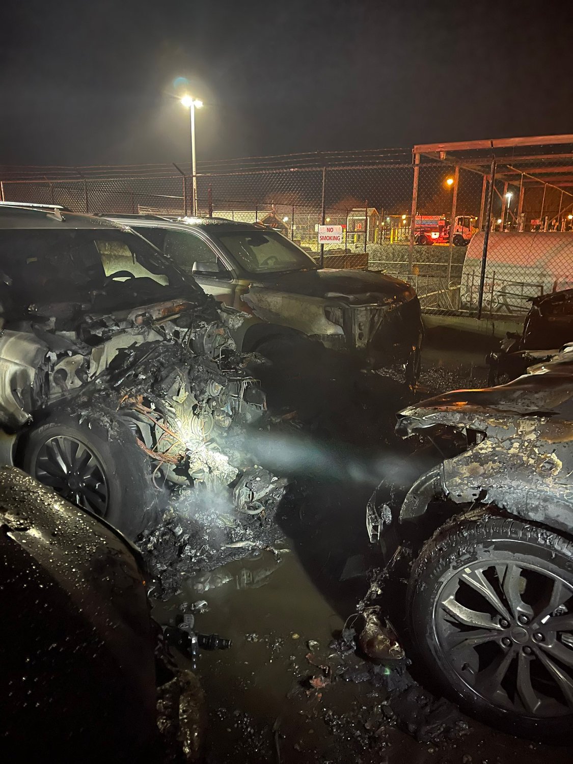 Heavy damage to vehicles in the airport rental-car overflow lot.