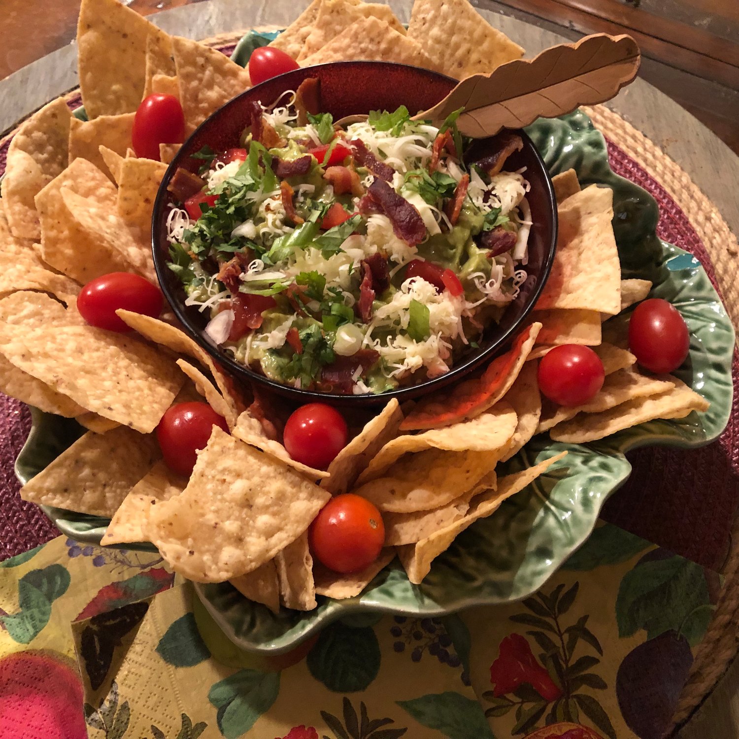 Winter Guacamole is kicked up a notch through the addition of crisp, crumbled bacon, cheddar cheese and plum tomatoes.