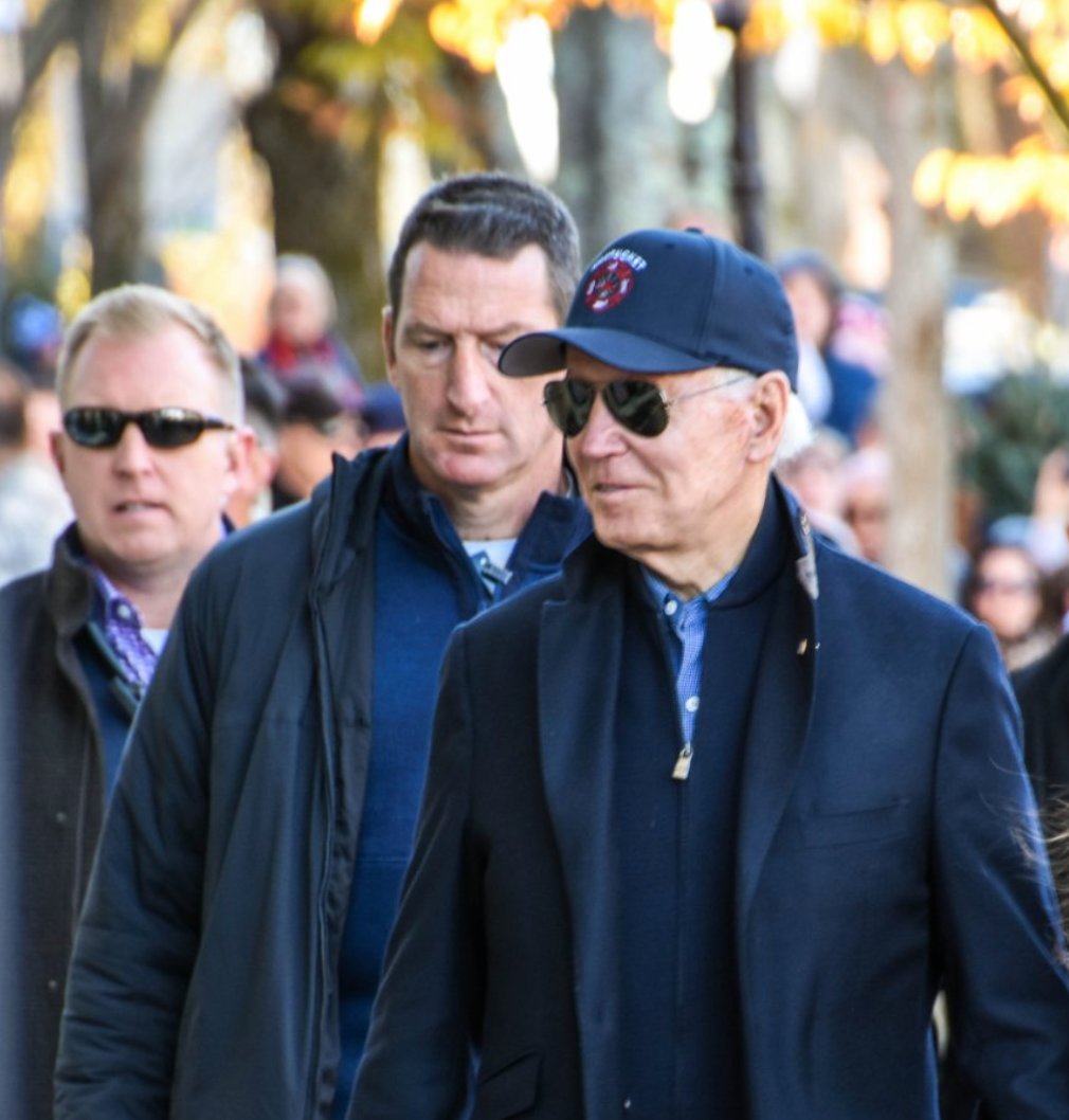 President Joe Biden, shadowed by Secret Service agents, on Main Street Saturday.