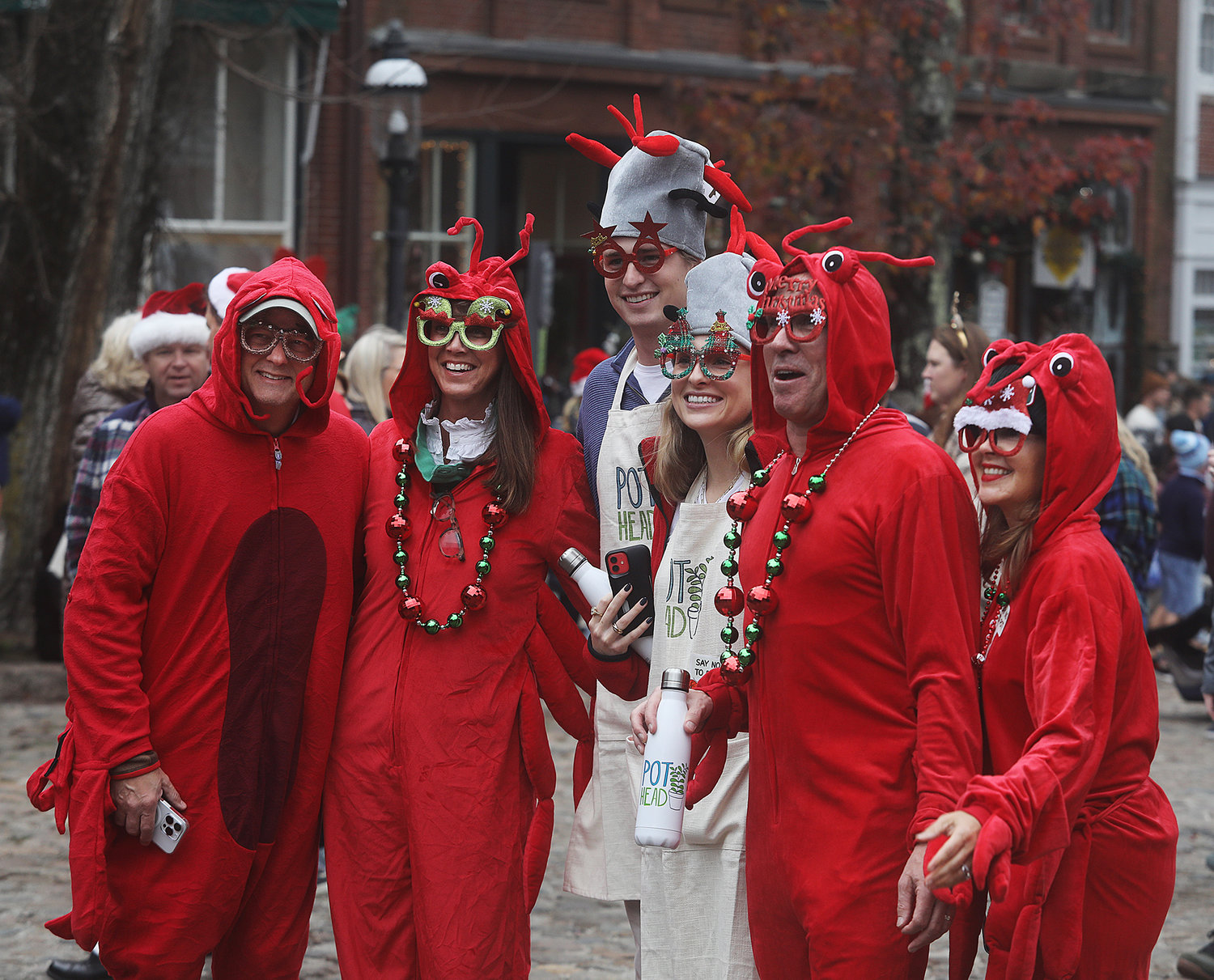 DECEMBER 3, 2022 -- A group of costumed lobster people  on Main Street during Christmas Stroll. Photo by Ray K. Saunders