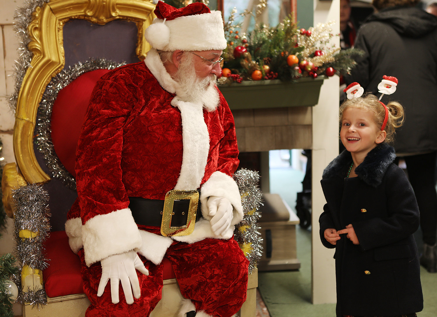 DECEMBER 3, 2022 -- Santa listens to the wishes of Charlotte Mangano, 5, of Portsmouth, NH, in the Discovery Room of the Whaling Museum during Christmas Stroll on Main Street. Photo by Ray K. Saunders