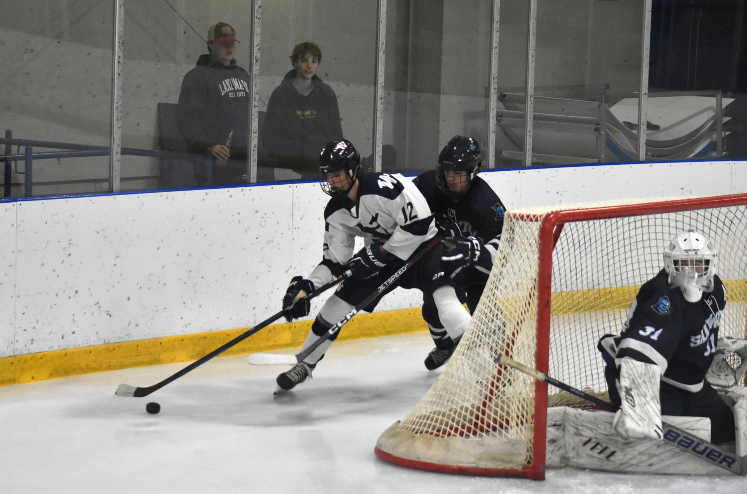 Ryan Davis works the puck around the net during the Whalers' 3-1 loss Wednesday at home against Sandwich. The junior scored his first goal of the season in the game.