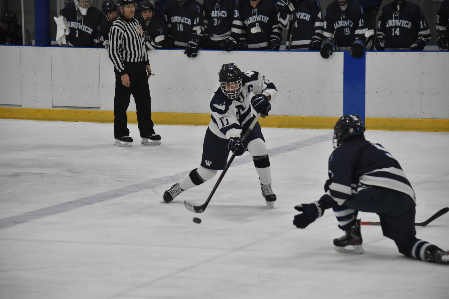 Jack Billings passes the puck around a Sandwich defender during last Wednesday’s 3-1 loss.