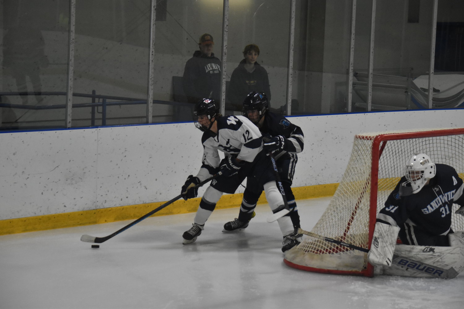 Ryan Davis works the puck around the back of the net during last Thursday’s game against Sandwich.