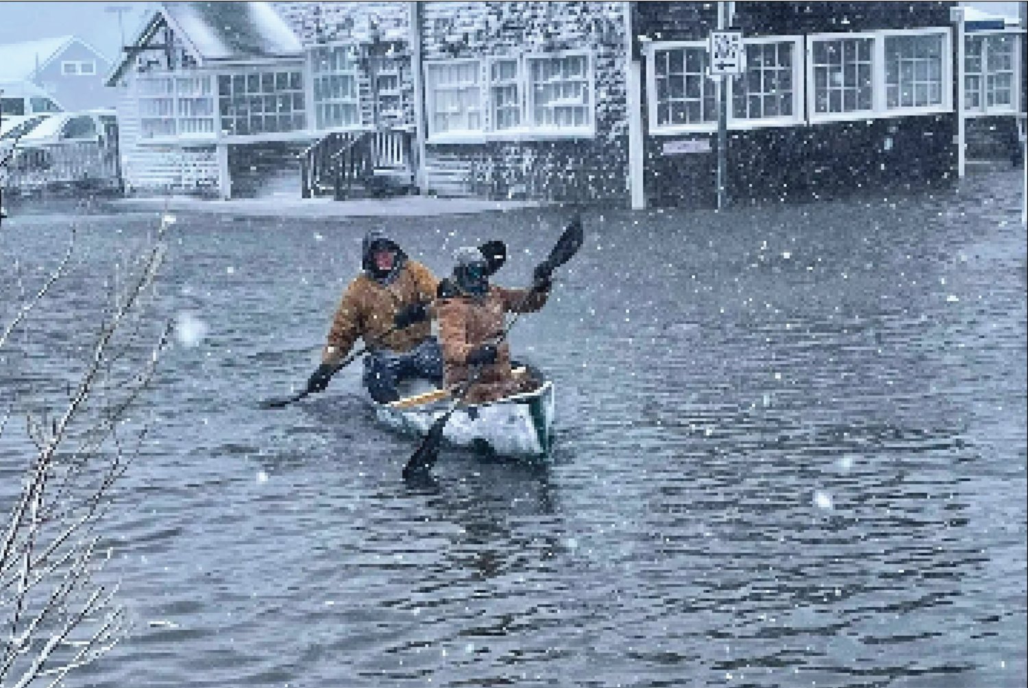 Ian Williams and Luke Stringer paddle down a flooded Broad Street during a powerful nor'easter at the end of January.