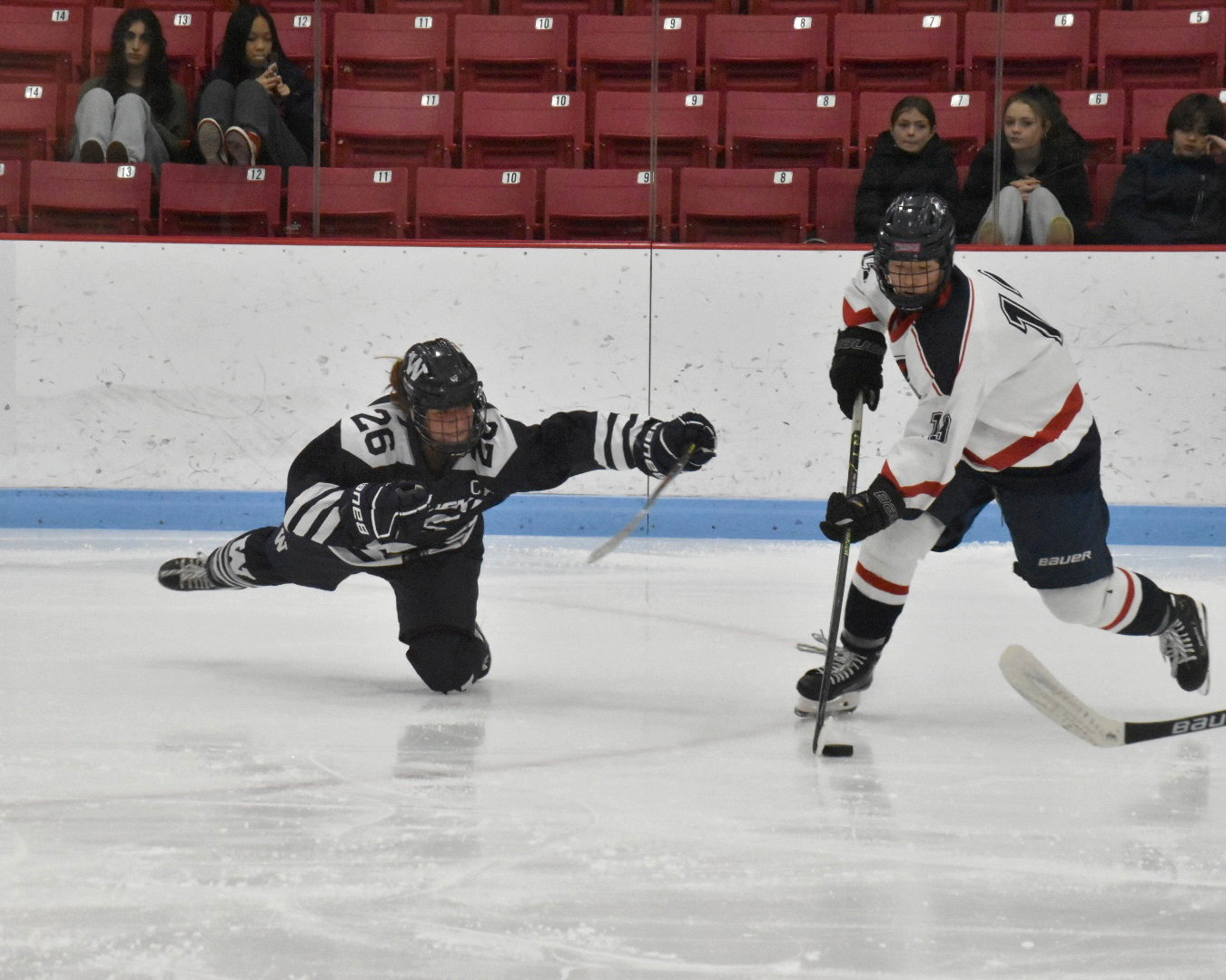 Claire Misurelli dives for a poke check during the Whalers 5-3 loss Thursday against Brookline.