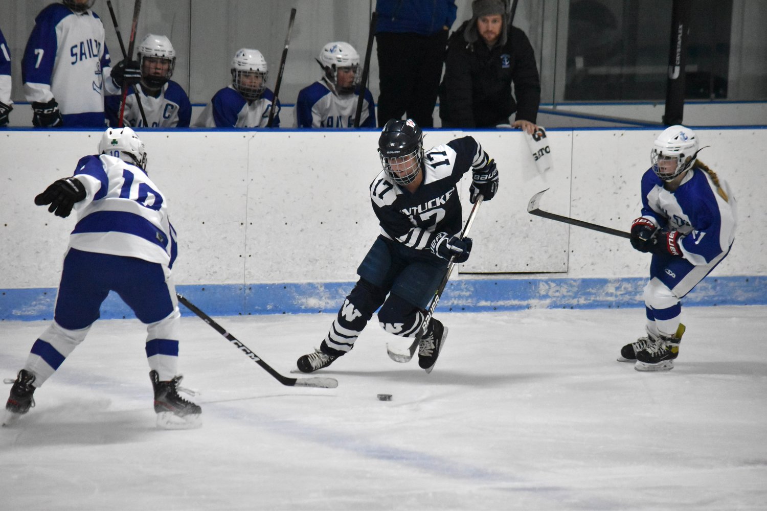Bailey Lower stick handles between Scituate players.