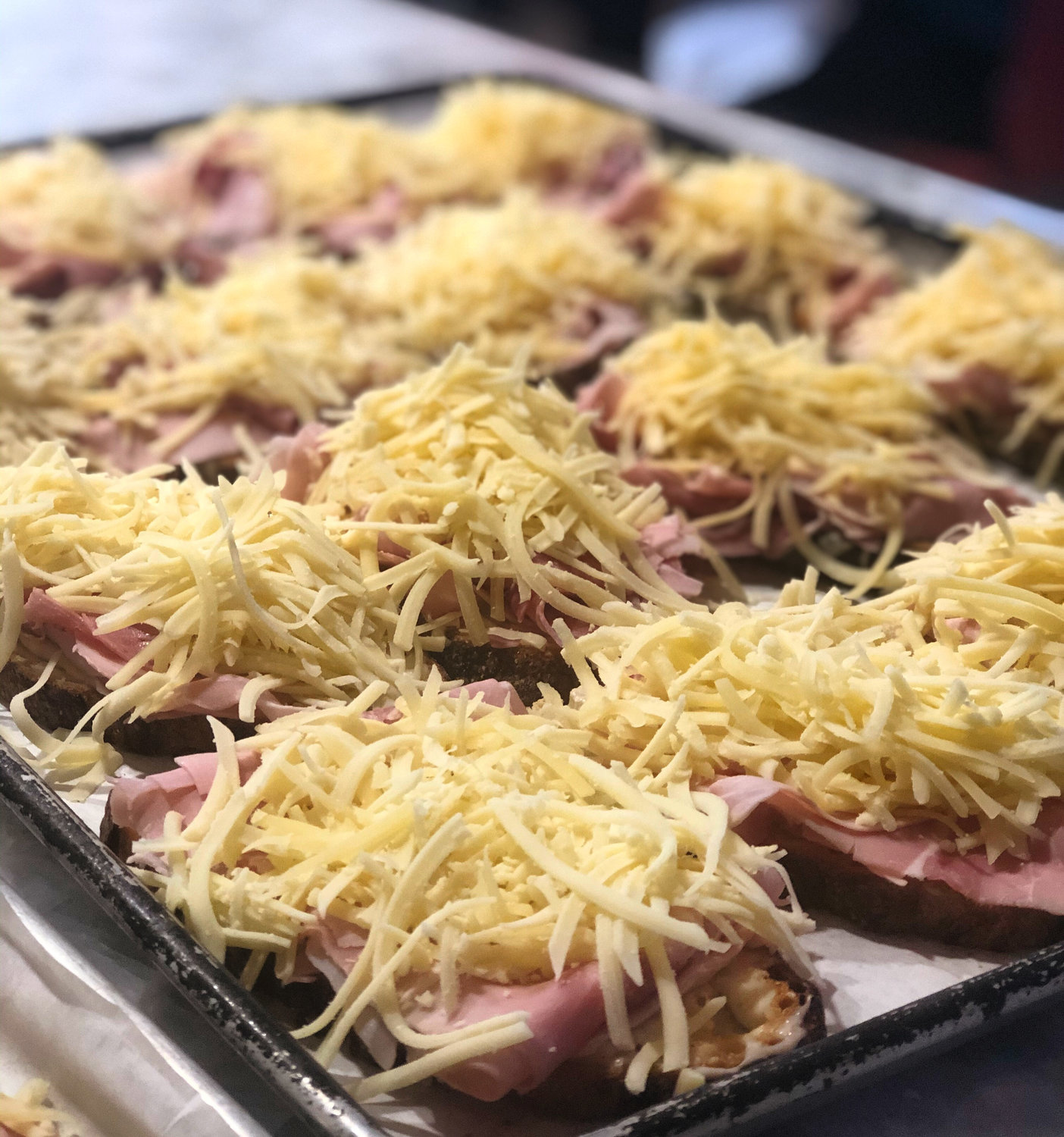 Preparing a tray of Croque Monsieurs at the Nantucket Culinary Center during the 2020 Elin Hilderbrand Bucket List Weekend.