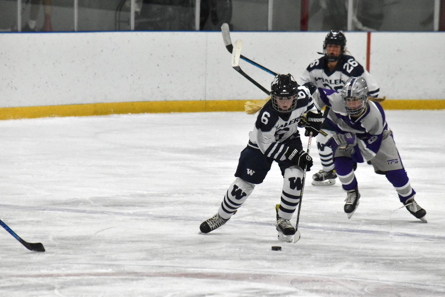 Grace Keane carries the puck during the Whalers’ Jan. 8 game against Martha’s Vineyard. The eighth-grader notched her first varsity point with an assist against Falmouth.