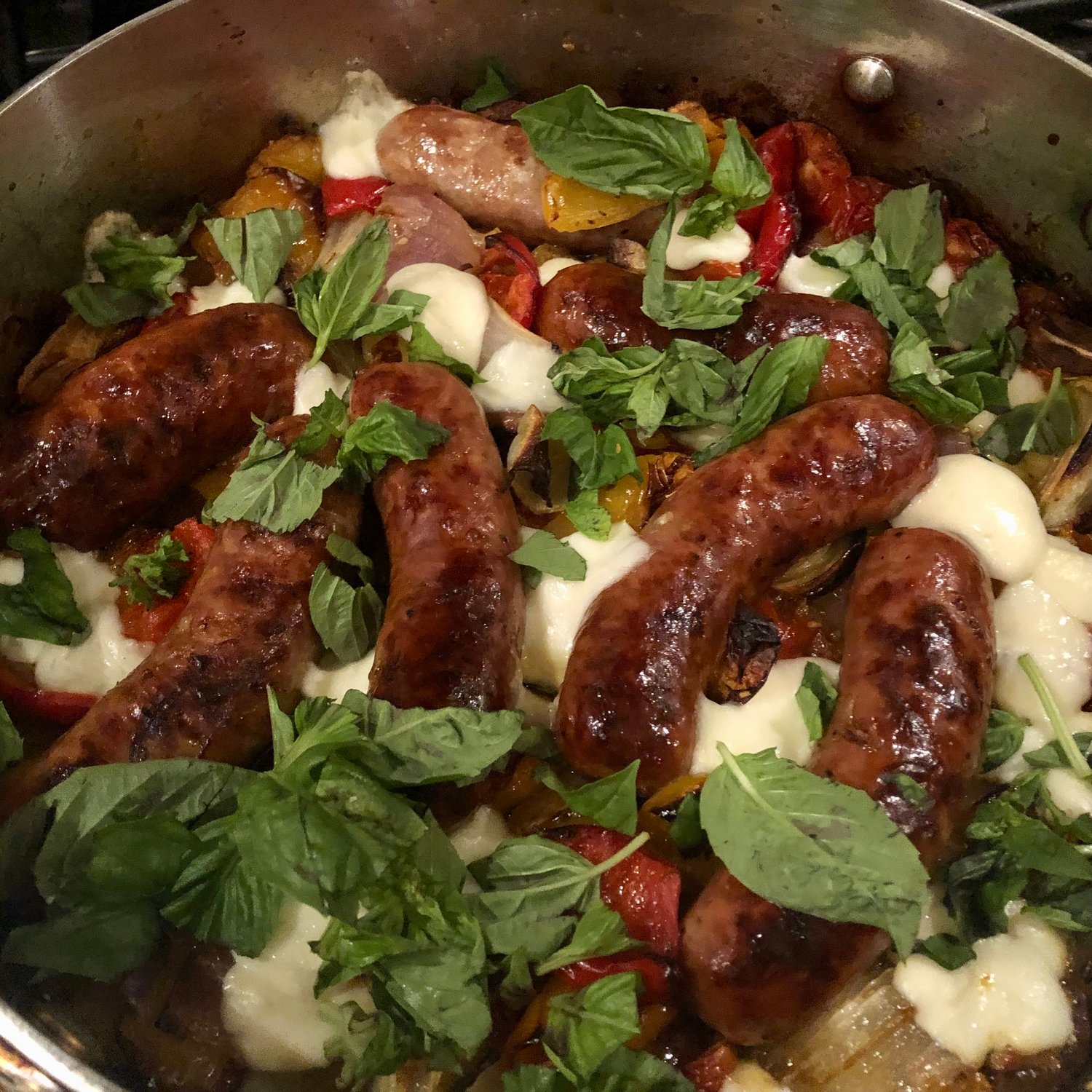 Nothing could be easier to make in winter than this delicious roasted sausage dish with peppers, onions, tomatoes and mozzarella cheese, garnished with basil.