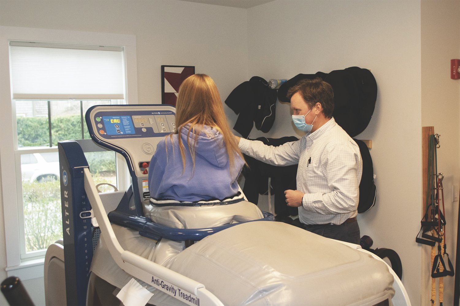 Joe Manning works with a client on the anti-gravity treadmill in his Amelia Drive office.