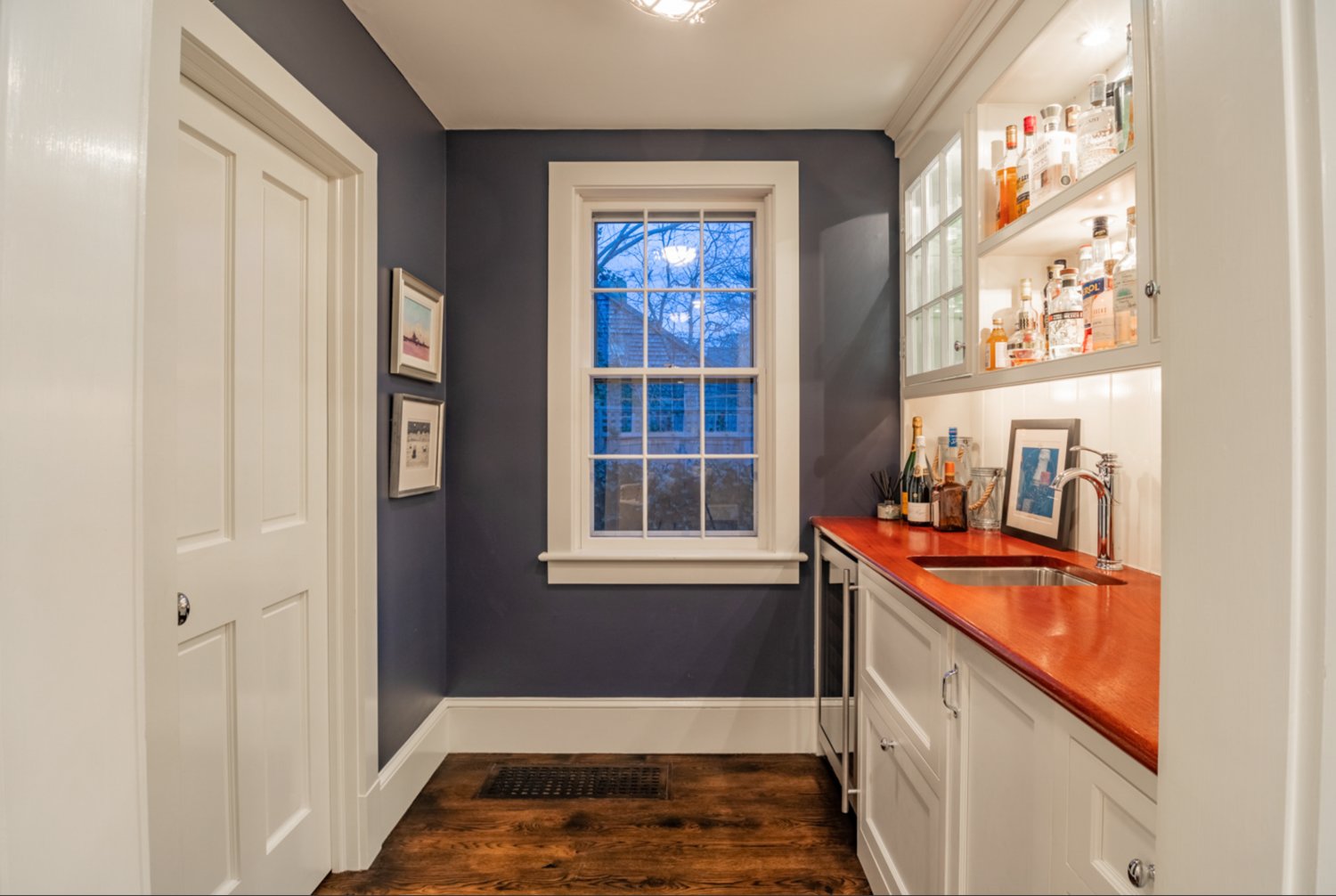 A custom-built wet bar is located outside the living room.