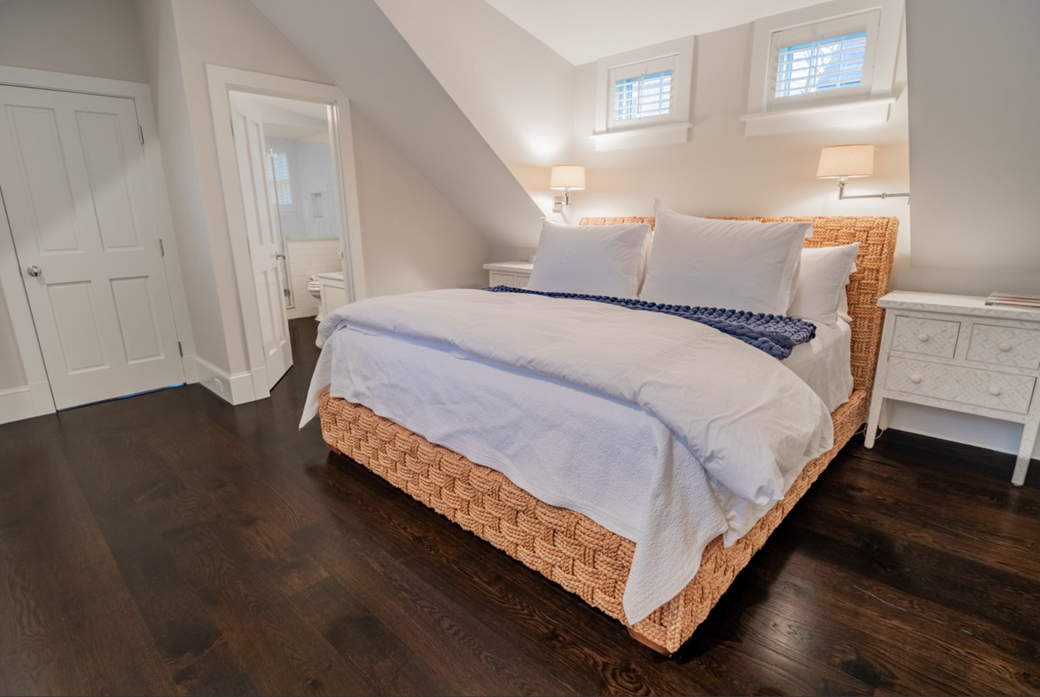 The second-floor master bedroom has a vaulted ceiling and wood floors.