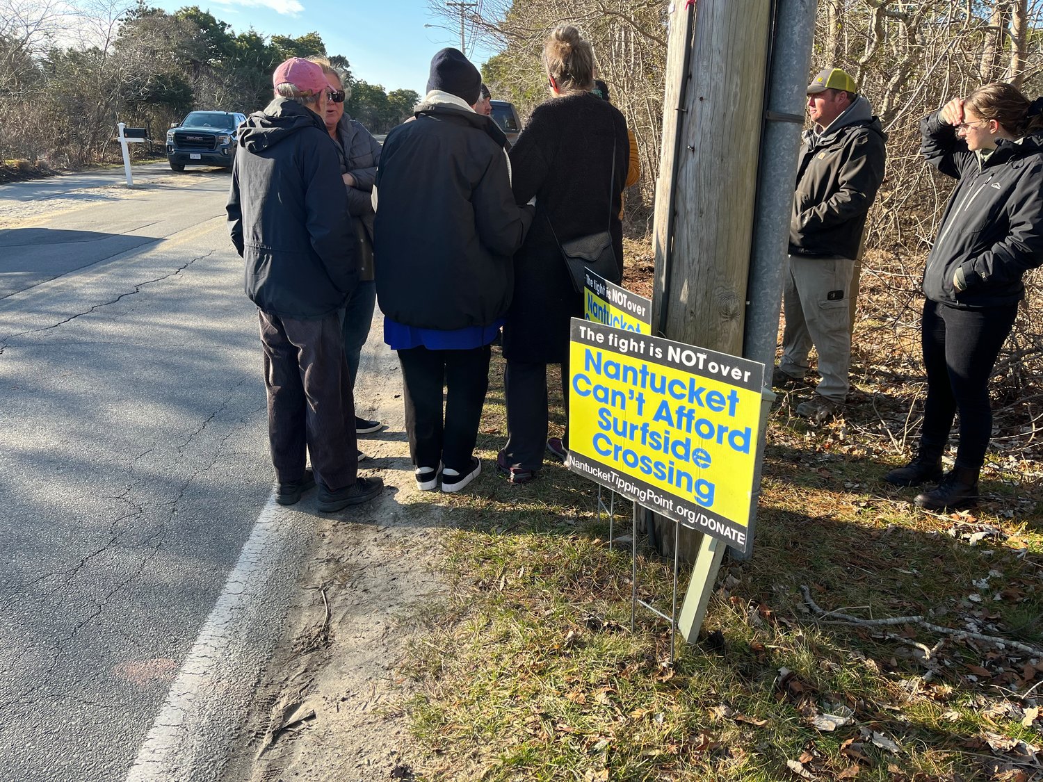 Opponents of the Surfside Crossing project just outside the property Saturday morning.