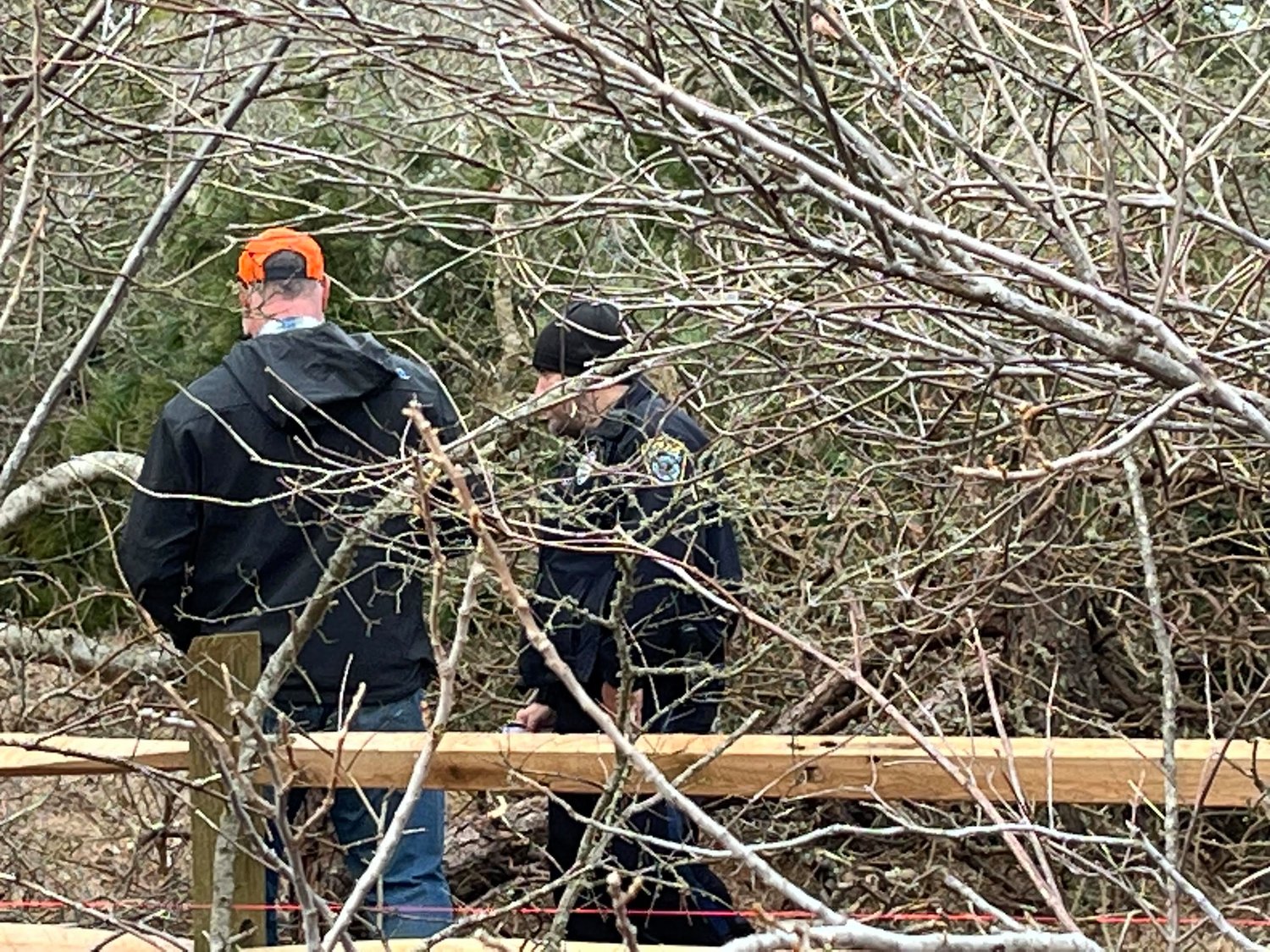 Surfside Crossing developer Jamie Feeley with a Nantucket police officer on the property Saturday.