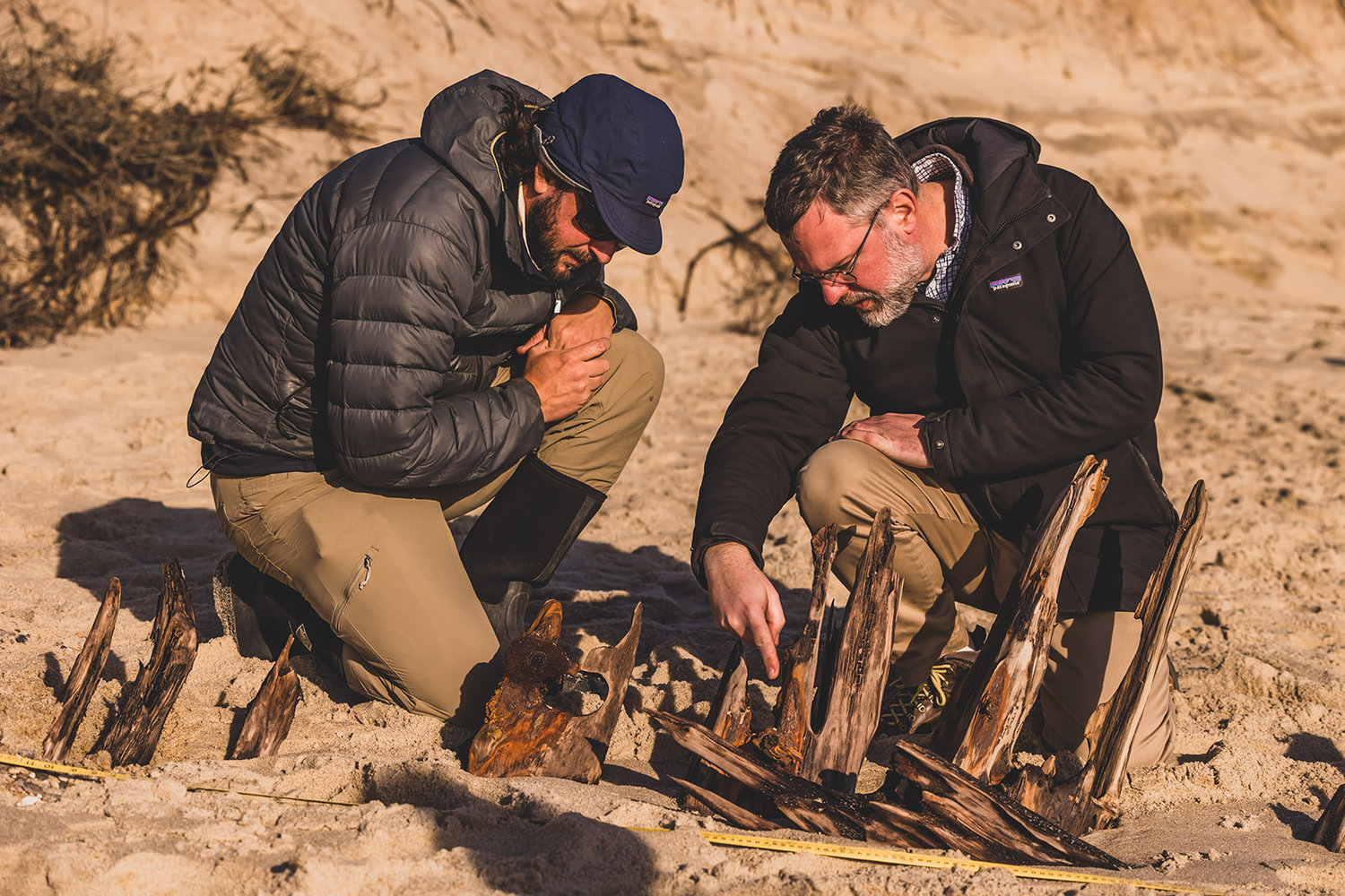 Researchers examine the wreckage in December.