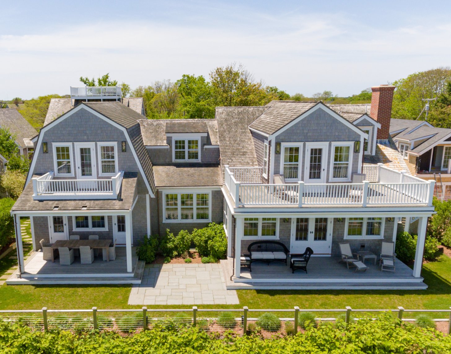 Located off prestigious Cliff Road, just steps from historic downtown Nantucket, the island’s best shops and restaurants, and around the corner from an abundance of family-friendly beaches, this four-bedroom, five-and-a-half bathroom home has sweeping harbor views.