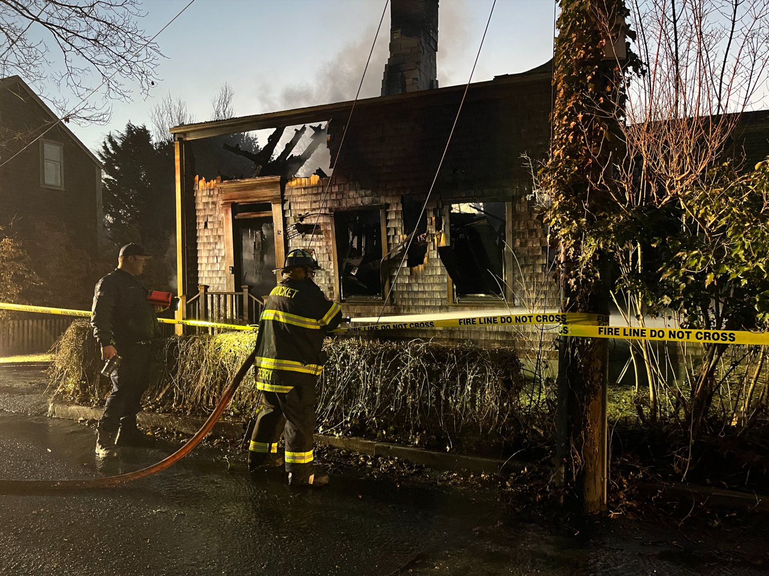Firefighters continue to wet down hot spots in a West York Lane home destroyed by fire early Thursday morning.