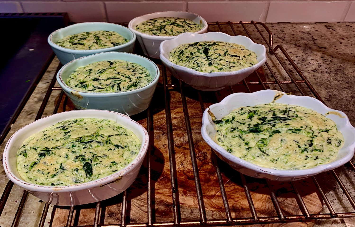 Make-ahead spinach and cheese soufflés can be completed in advance of your guests’ arrival, and accommodate many food restrictions. They’re pretty tasty, too.