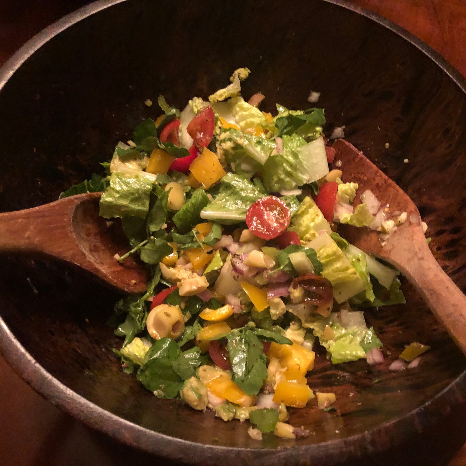 The Steak House Salad from the Rose Pistola Cookbook features bright flavors from olives, cherry tomatoes, avocado and peppers, tossed in a red wine vinaigrette.