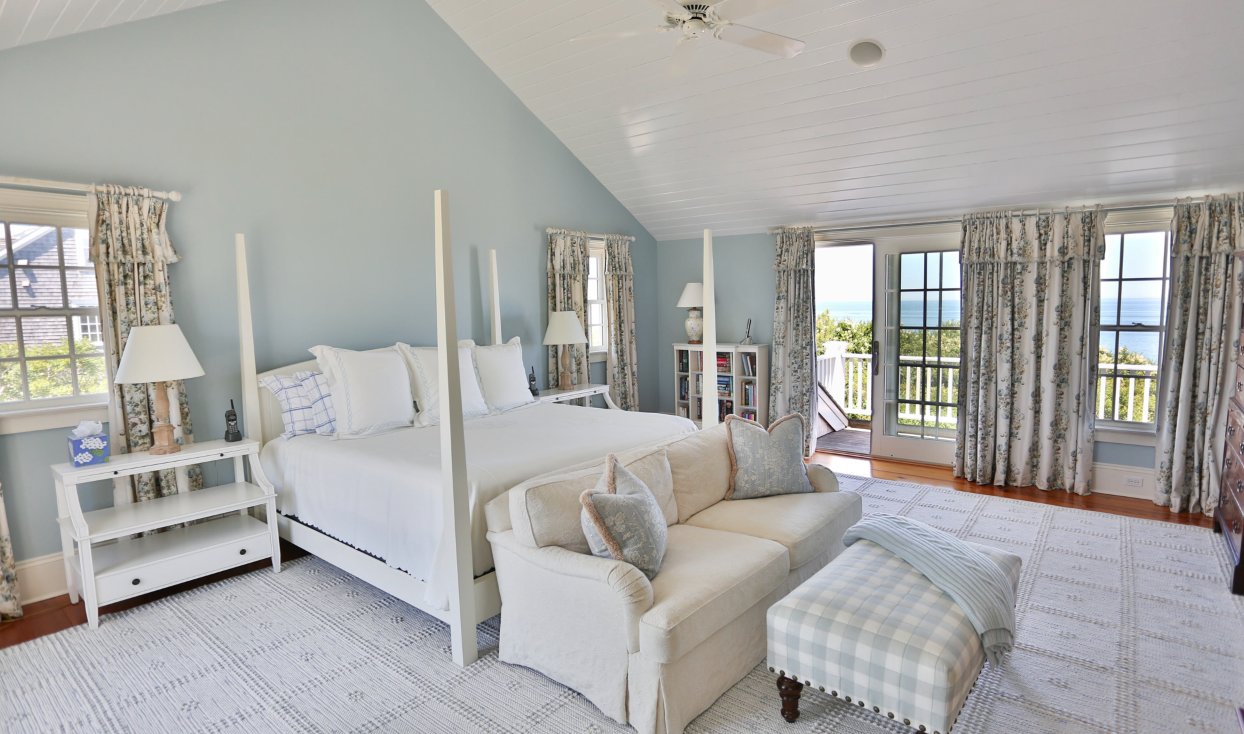 This bedroom has a vaulted ceiling and a private deck.