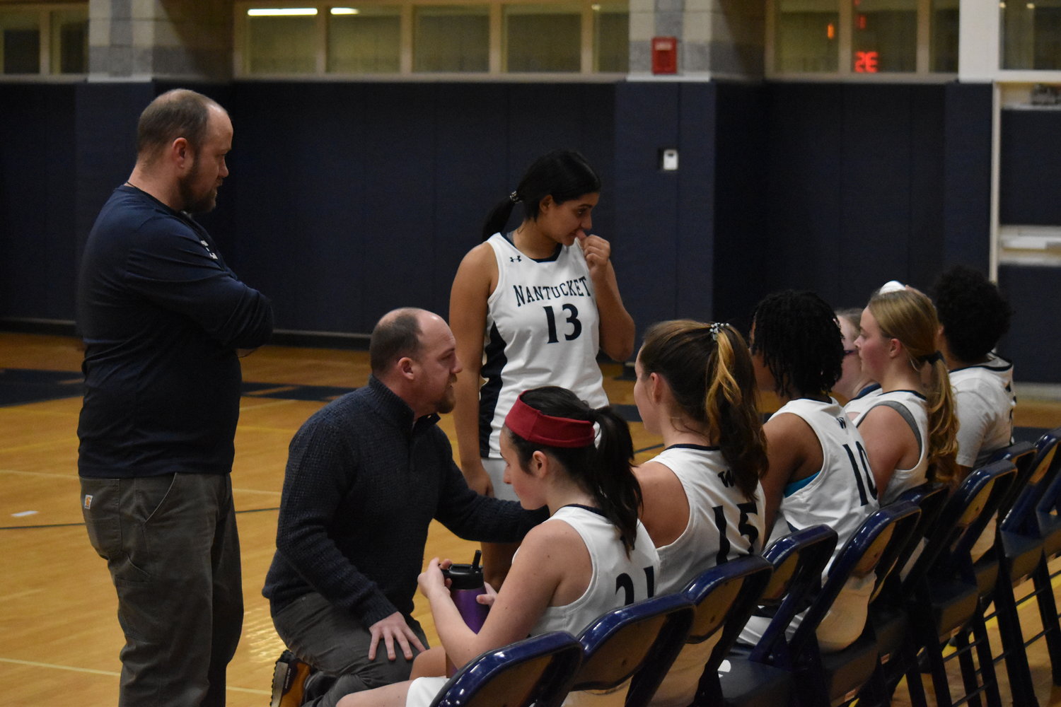 The JV girls basketball team during a timeout Dec. 27 against Barnstable.