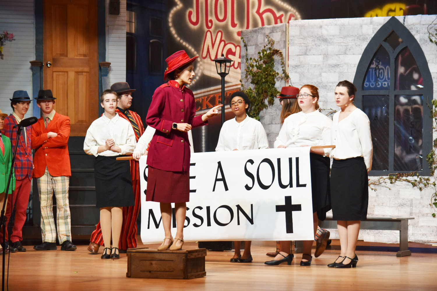 Chloe Girvin, center, portrays Sarah Brown, the principled leader of the Save-a-Soul Mission, in the Nantucket High School production of “Guys and Dolls.”