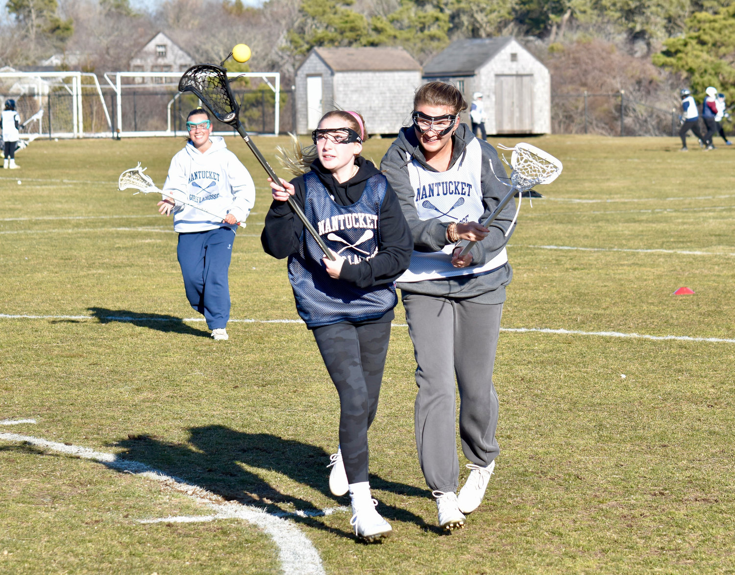 Grace Keane and Ella Finlay battle for a loose ball during Monday's girls lacrosse practice, the first day of spring sports at NHS.