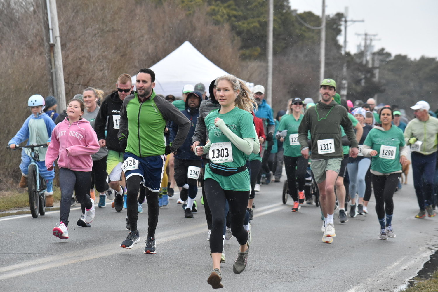 Molly O’Mara (1303) leads a pack of runners and walkers at the start of Saturday’s ShamRock Run.