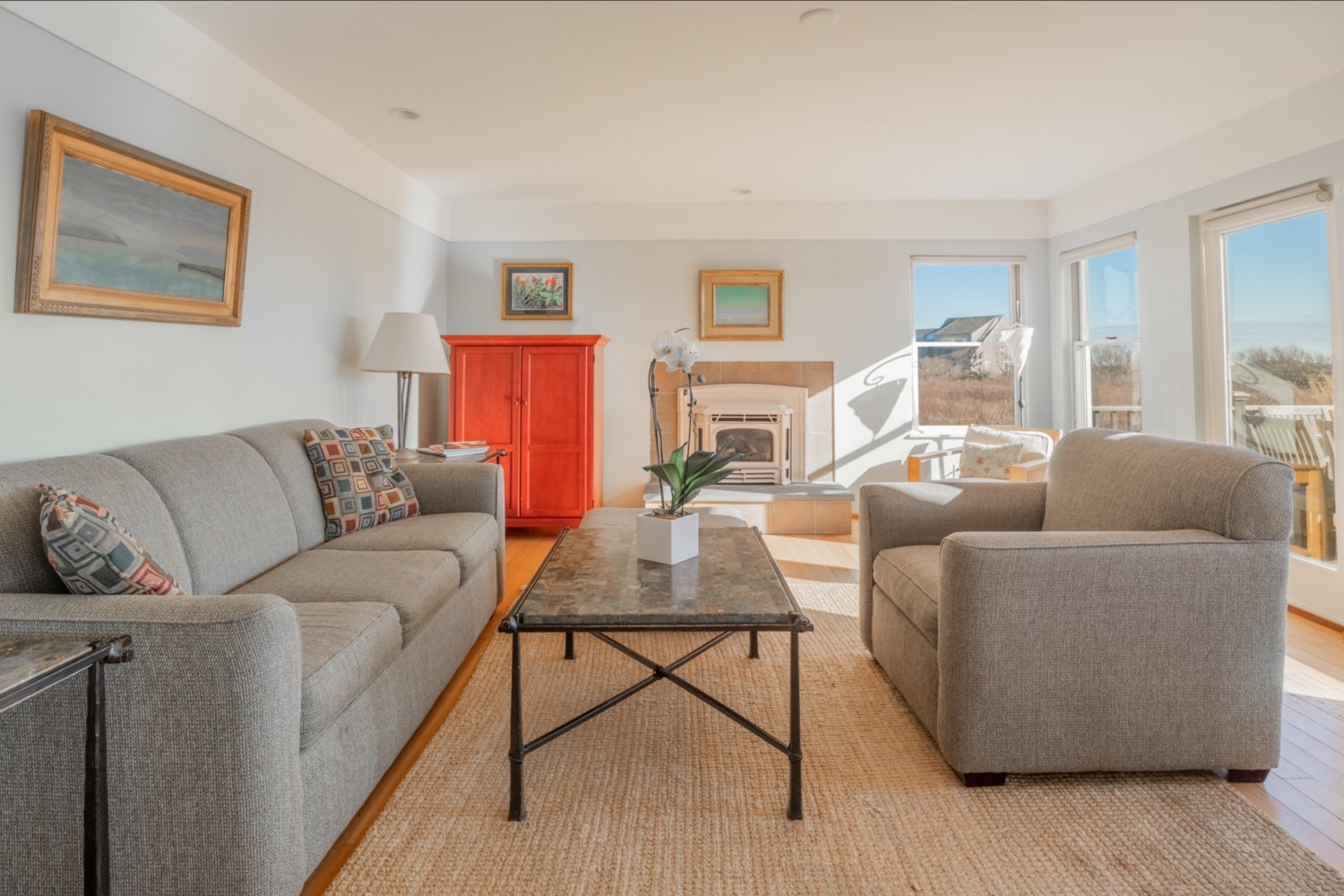 The living room has a gas fireplace and French doors that open to the south-facing deck that overlooks Miacomet Pond and the Atlantic Ocean.