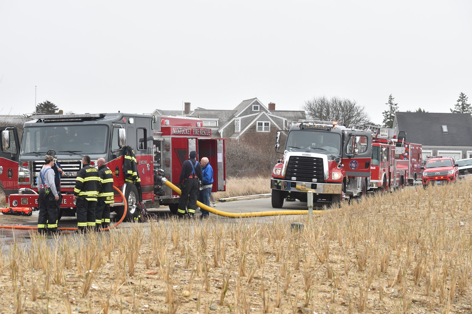 Firefighting vehicles staged outside 7 Cannonbury Lane Thursday.