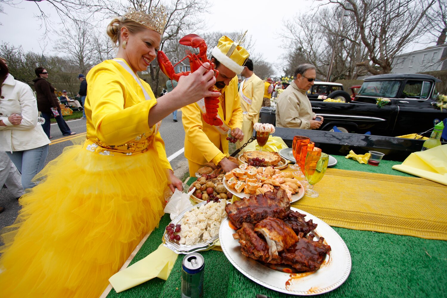 photo by Jim Powers--.Candy Bearman and David Bartlett set up the tailgate picnic in Sconset on the Bartlett's Farm entry during the annual Daffodil Festival events on Saturday, April 25, 2009.