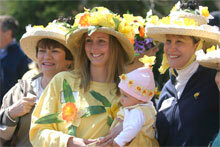photo by Jim Powers.Entrants in the hat contest await the judge's decisions at the Harbor House during the 2004 Daffodil Festival. At center is the winner of the adult award Dana Wasley of Farmington, Ct., and her daughter Mia Kelley, age 9 months.