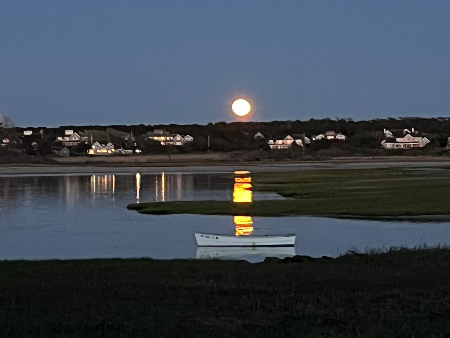 The full flower moon rises over Nantucket Harbor Friday.