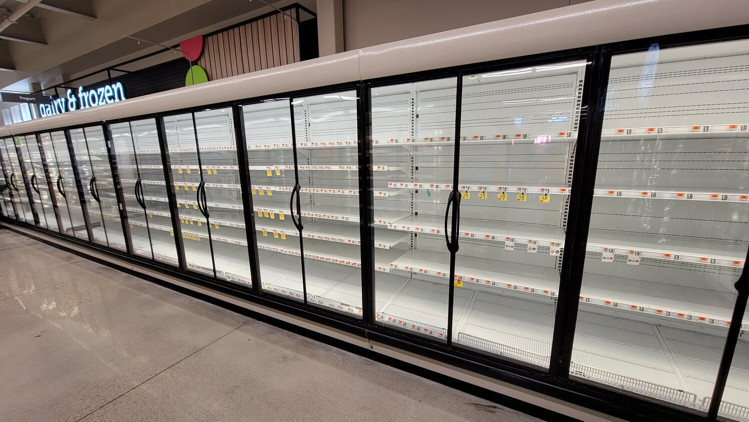 Empty refrigerator cases at the mid-island Stop & Shop Monday morning.