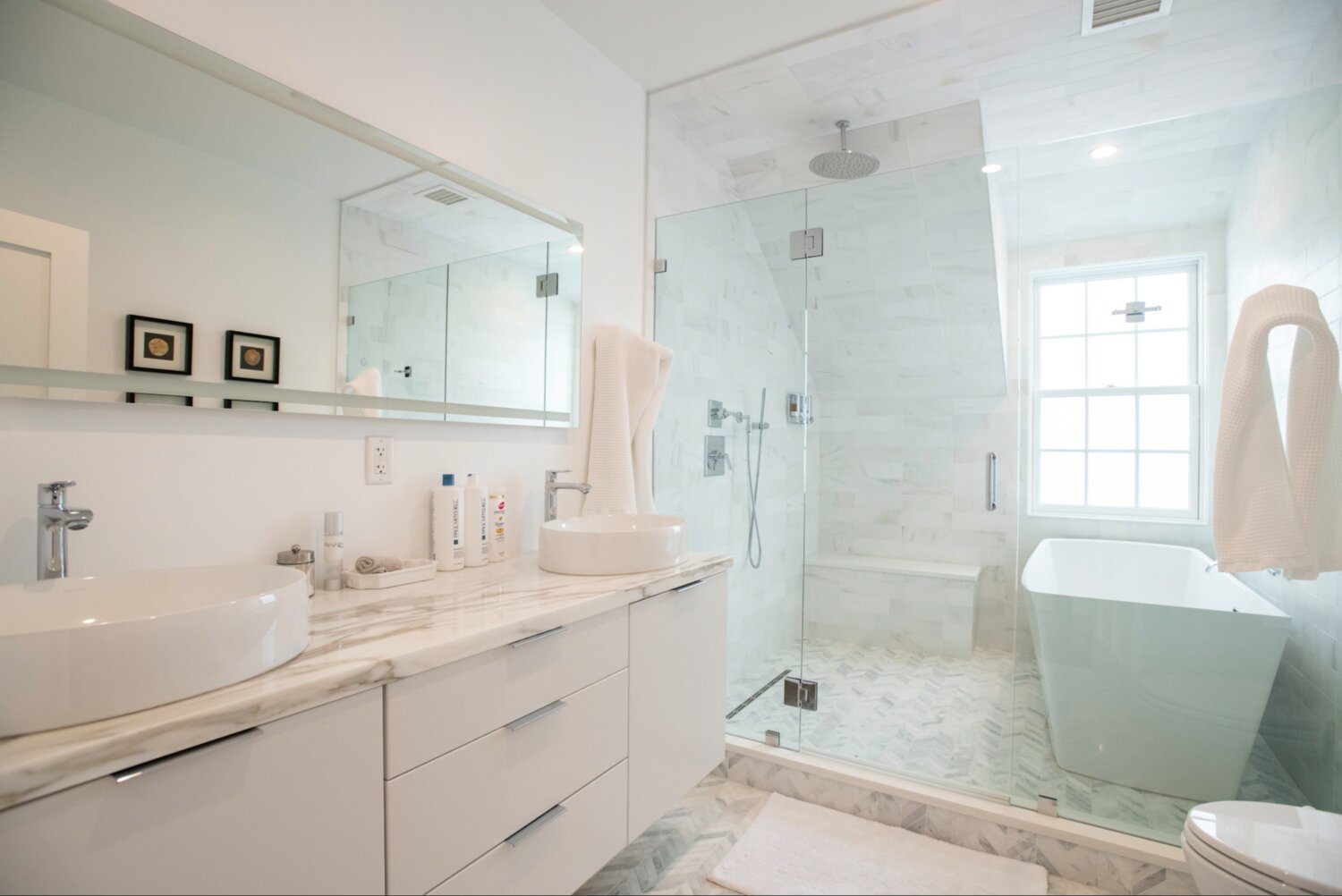 The master bath has dual vanities, a soaking tub and glass-enclosed shower.