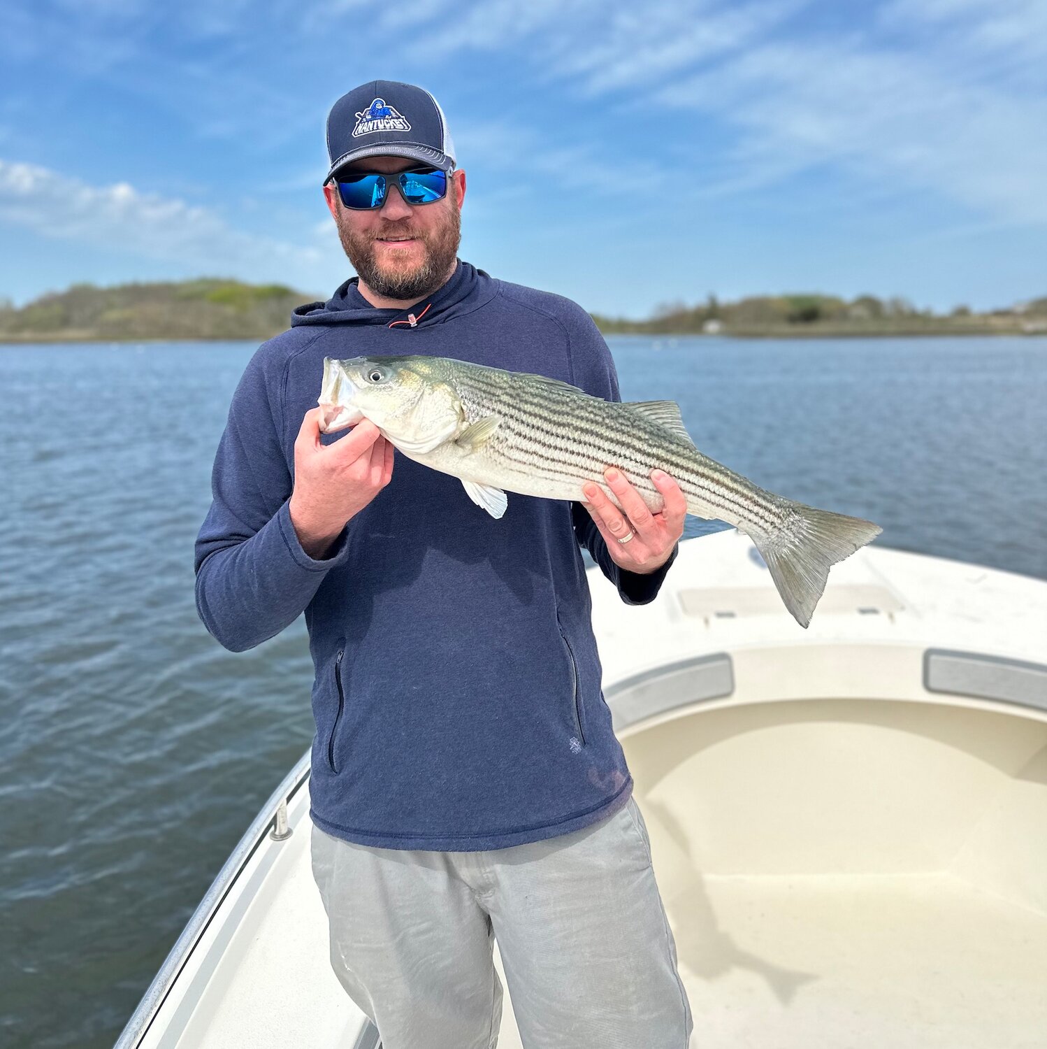 Chris Cothran with a striped bass in Nantucket Harbor.