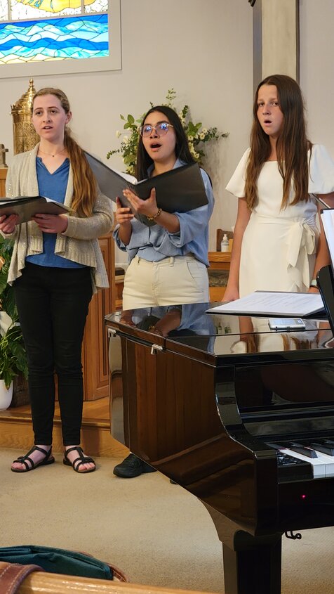 From left, Maria Frable, Adriana Salazar and Liepa Skehel sing at St. Mary’s Catholic Church.