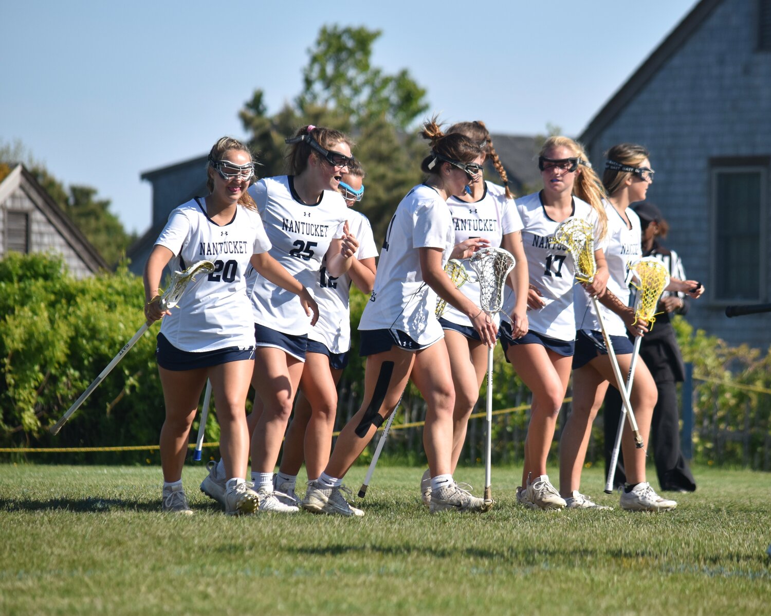 The girls lacrosse team celebrates after a goal Thursday against Cape Cod Academy. The Whalers wrap up the regular season at home Saturday against Martha's Vineyard at 11 a.m.