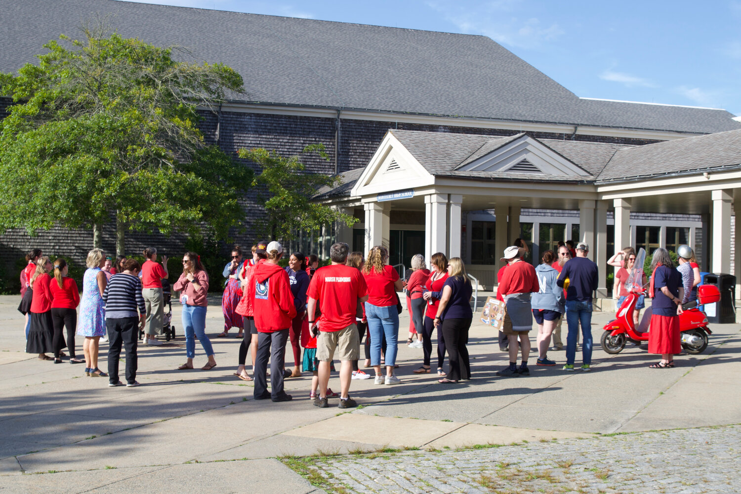 Supporters of a better-paying teachers' contract, dressed in red, outside Nantucket High School Tuesday night.