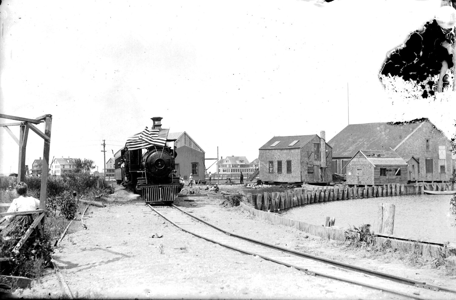 Bedecked with flags for Independence Day, Nantucket Central Railroad Engine No. 1 leaves Steamboat Wharf in July 1901.