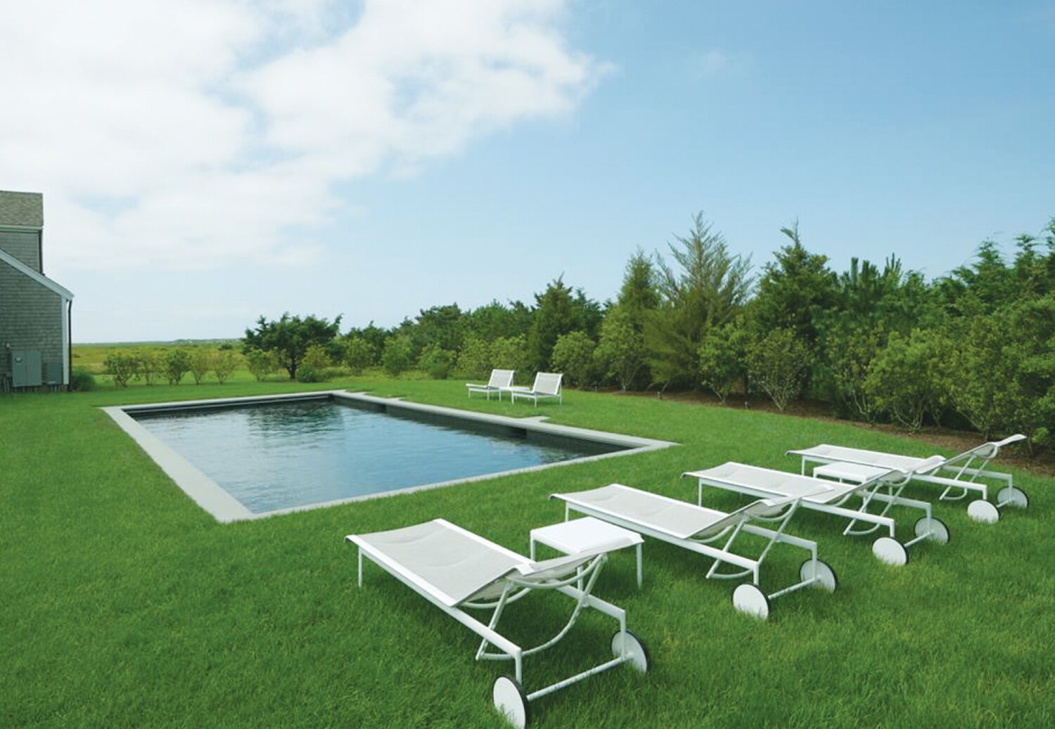 The in-ground pool is surrounded by the meticulously-manicured lawn, and just steps from the rear of the house.