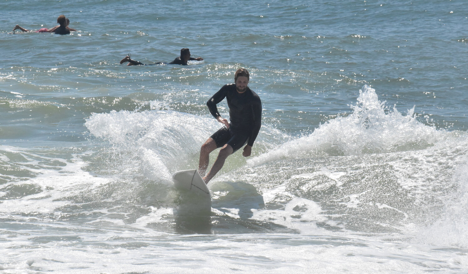 With a high surf advisory in effect, dozens of surfers hit the water along the south shore Friday.