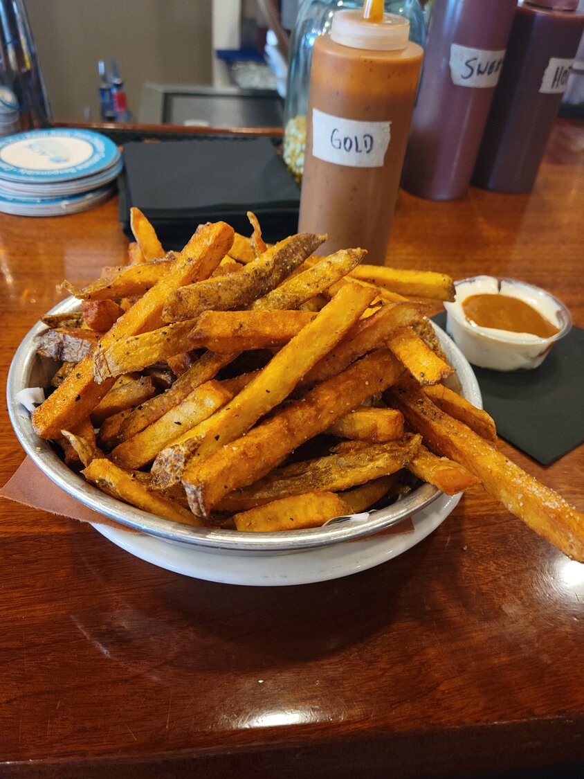 B-ACK Yard BBQ’s signature fries with a side of gold sauce and mayonnaise.