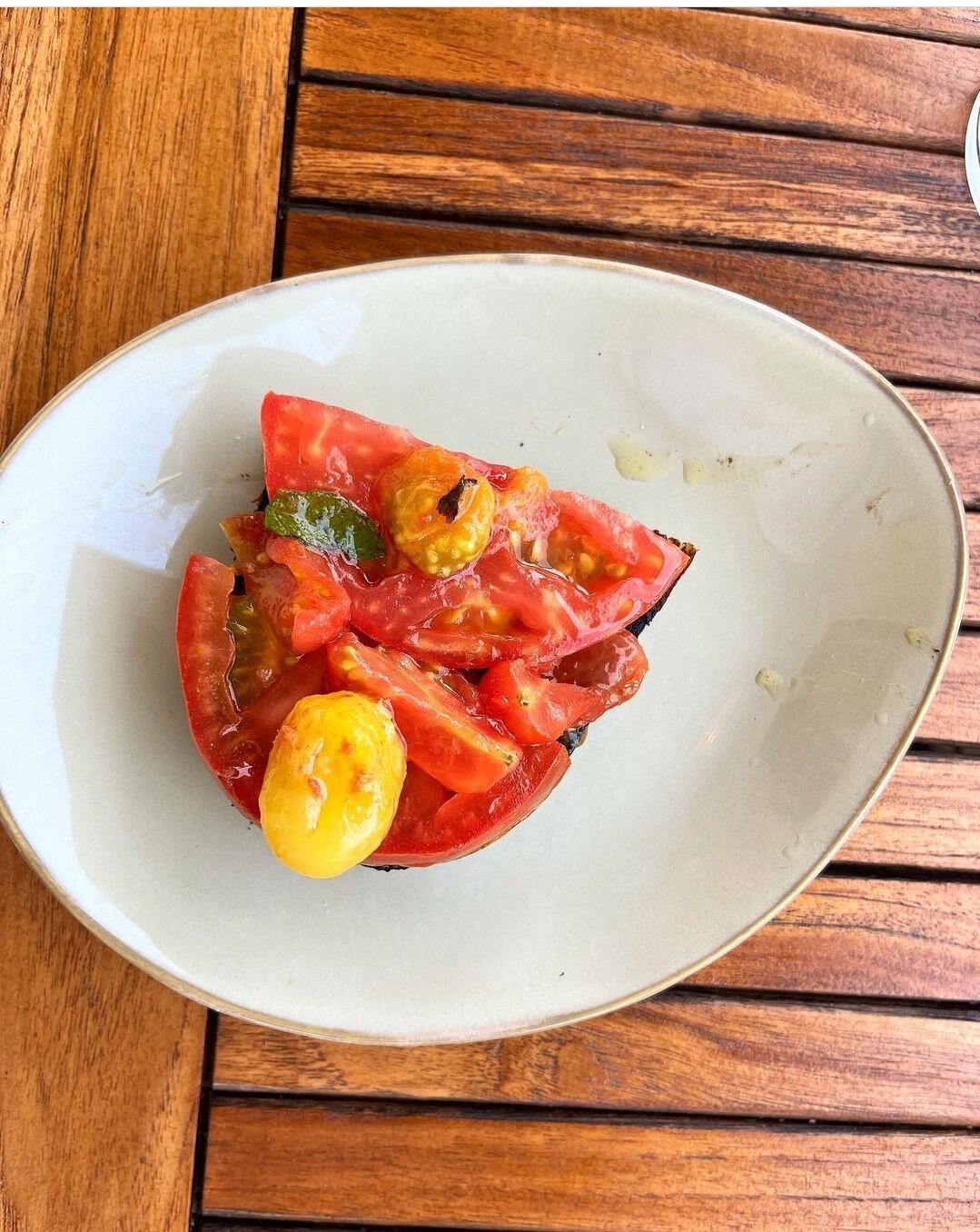 Via Mare’s Tomato Toast is spread thinly with tomato jam, then topped with beefy heirloom and blistered cherry tomatoes from Fog Town Farm.