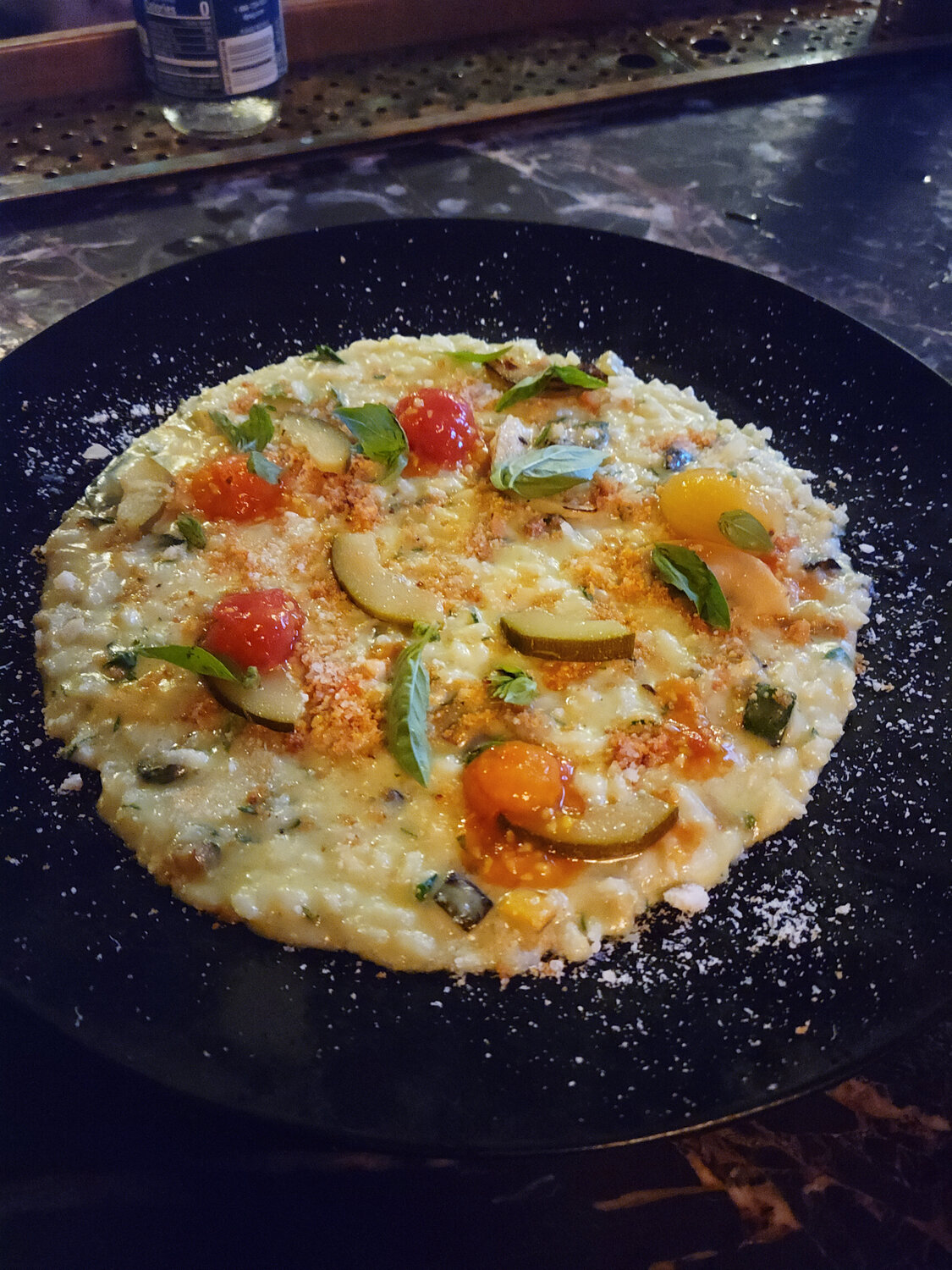 The Vegetable Risotto is made with sautéed zucchini and summer squash, tomatoes and zucchini escabeche, zucchini marinated in vinegar and spices.