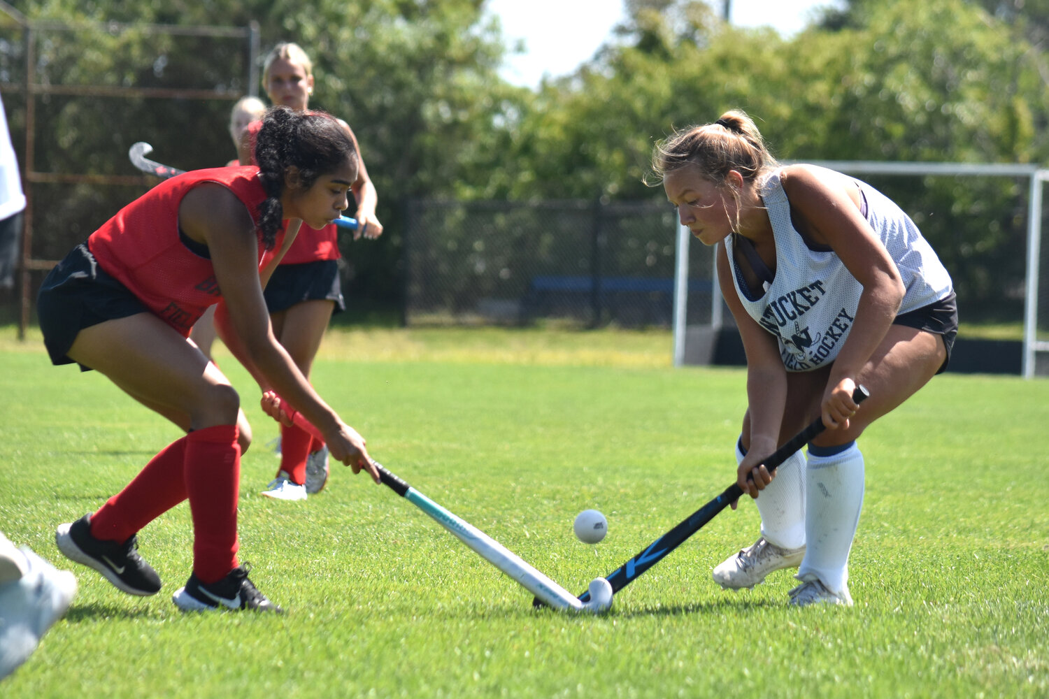 Suz Peraner and a Barnstable player reach for the ball during Friday's scrimmage.