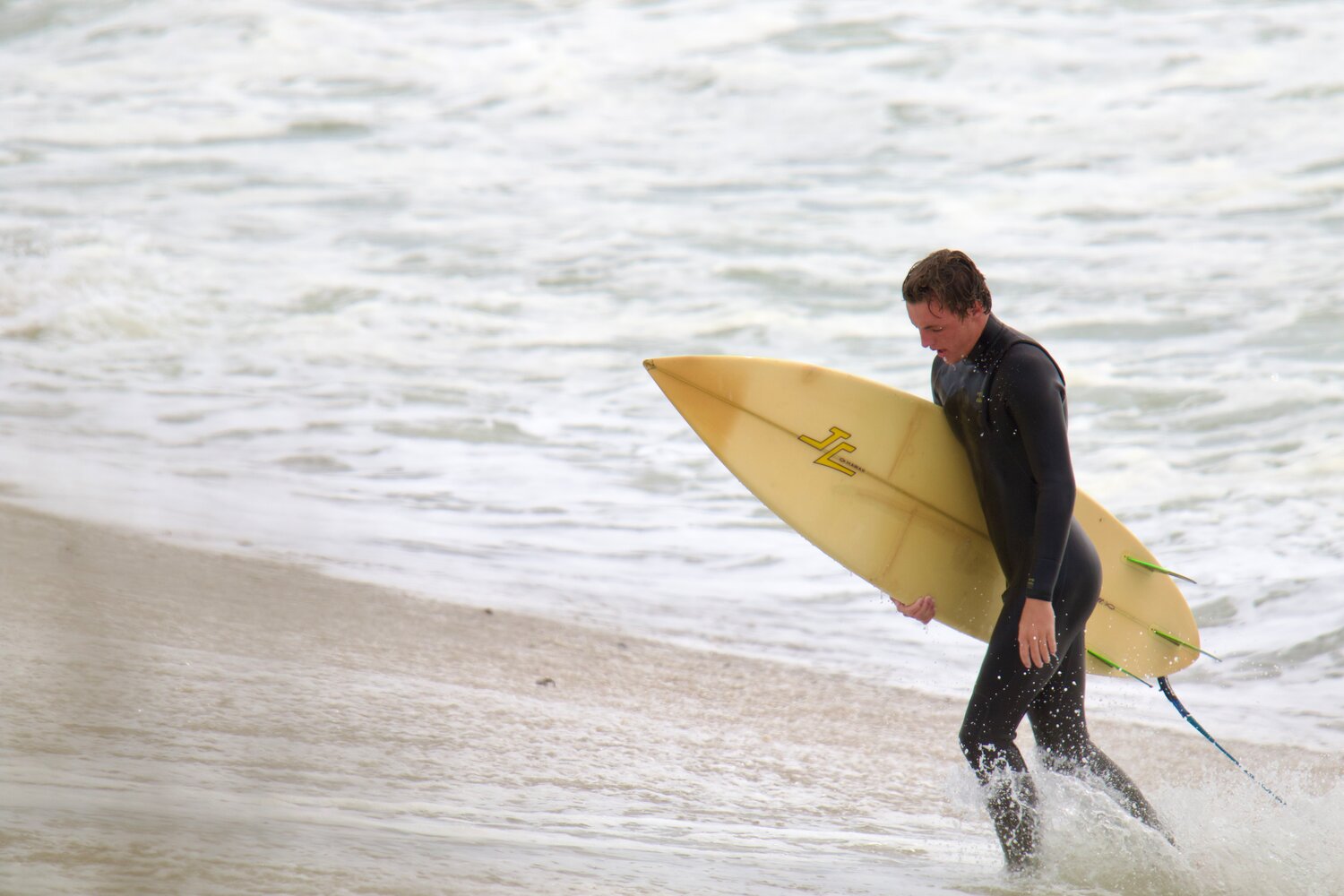 A surfer exits the water in Maddequecham Friday.